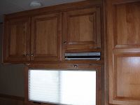 Maple cabinets above bed w/media player and reading lights