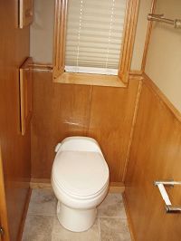 Toilet room w/walnut wainscot & ceramic tile floor