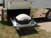 BBQ grill on sliding metal tray for easy access